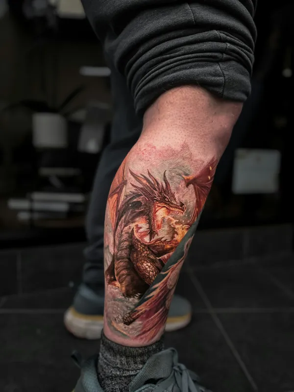 Color realism dragon tattoo covering a calf