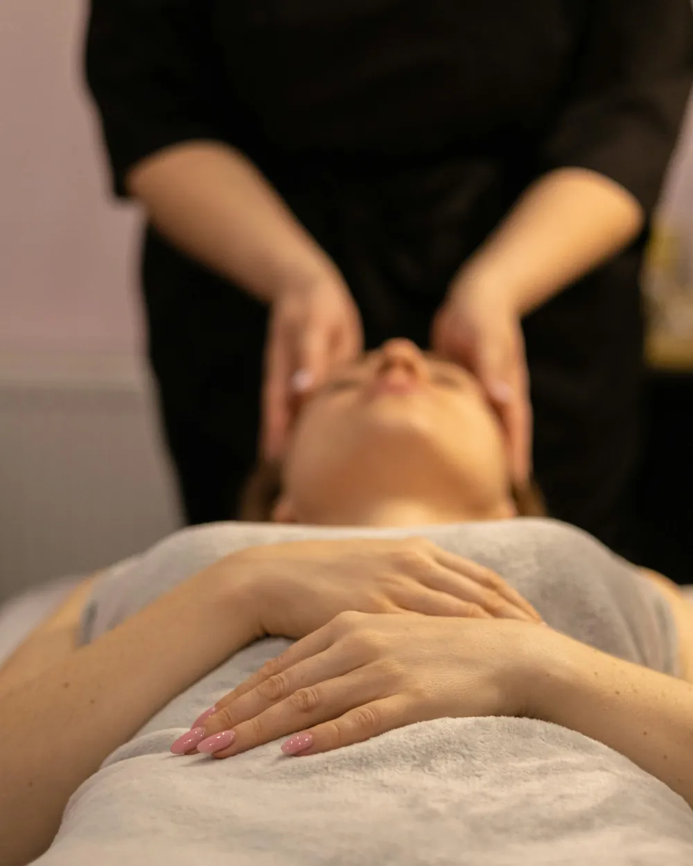 A calm facial massage, the client resting under a soft towel